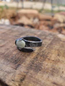 This alchemy inspired ring was handmade in the forge. It is set with a jade, making a stunning piece of rustic jewelry.
