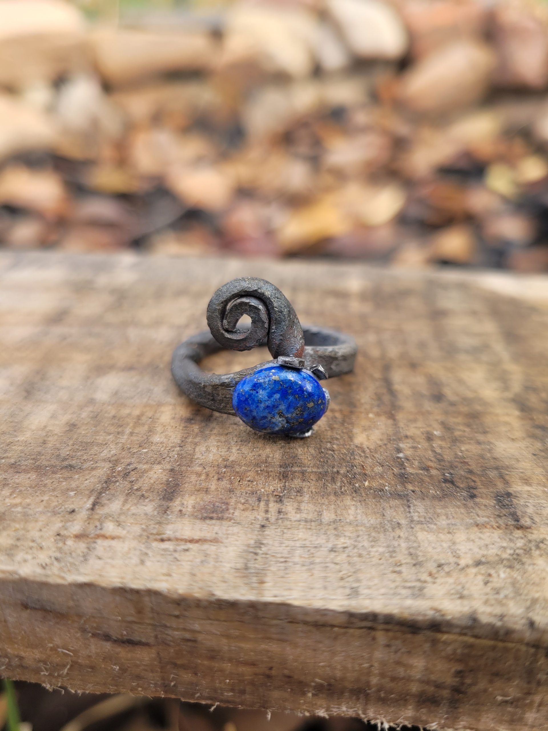A hand forged ring made from an old nail and a lapis lazuli gemstone