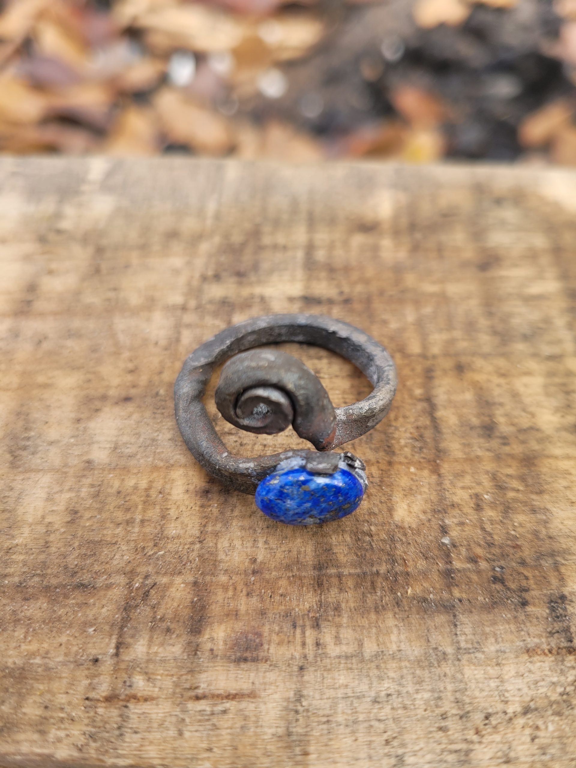 A hand forged ring made from an old nail and a lapis lazuli gemstone
