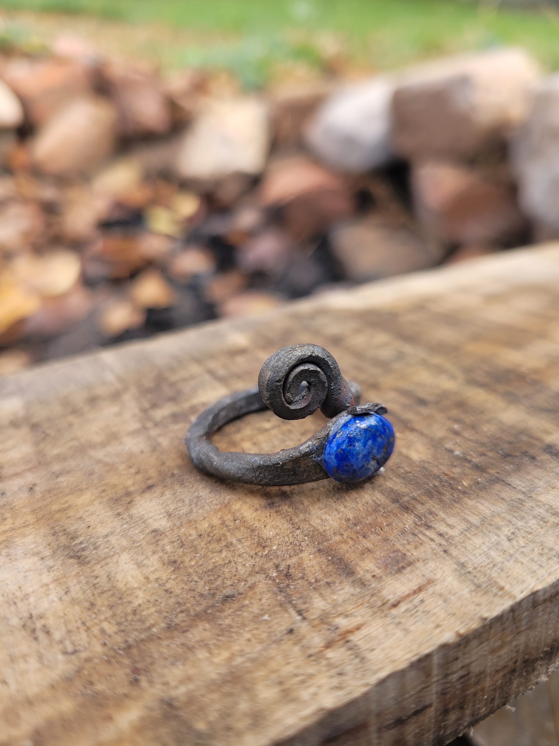 A hand forged ring made from an old nail and a lapis lazuli gemstone