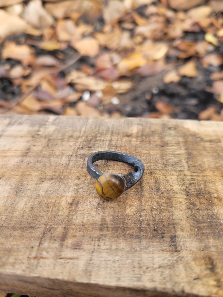 A hand forged ring made from an old nail and a tiger's eye stone.