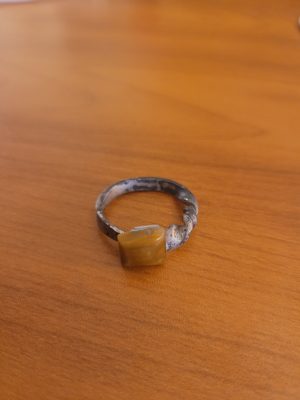 An alchemy inspired ring that was hand forged from an old nail. It is set with a square tiger's eye gemstone