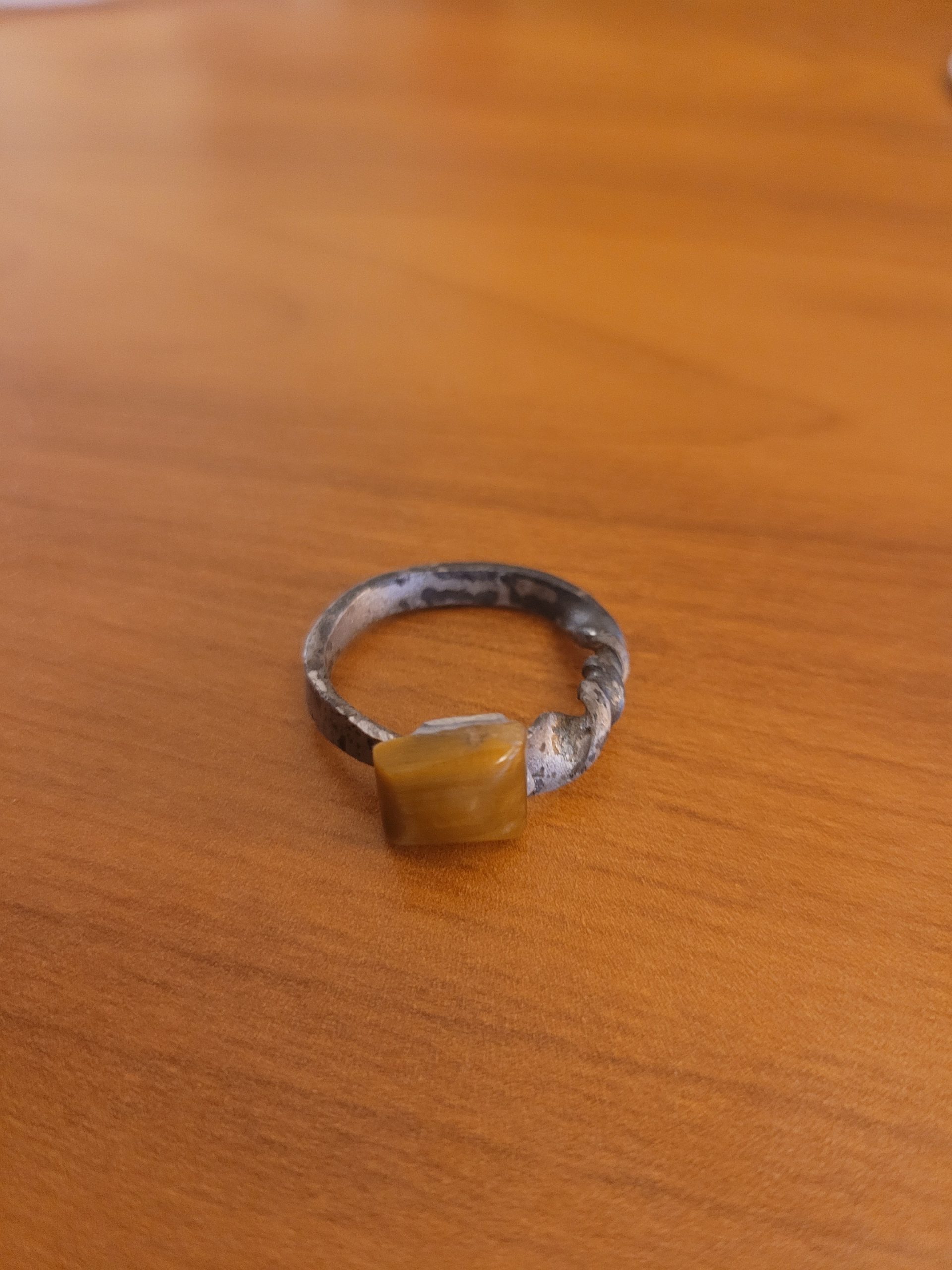 An alchemy inspired ring that was hand forged from an old nail. It is set with a square tiger's eye gemstone