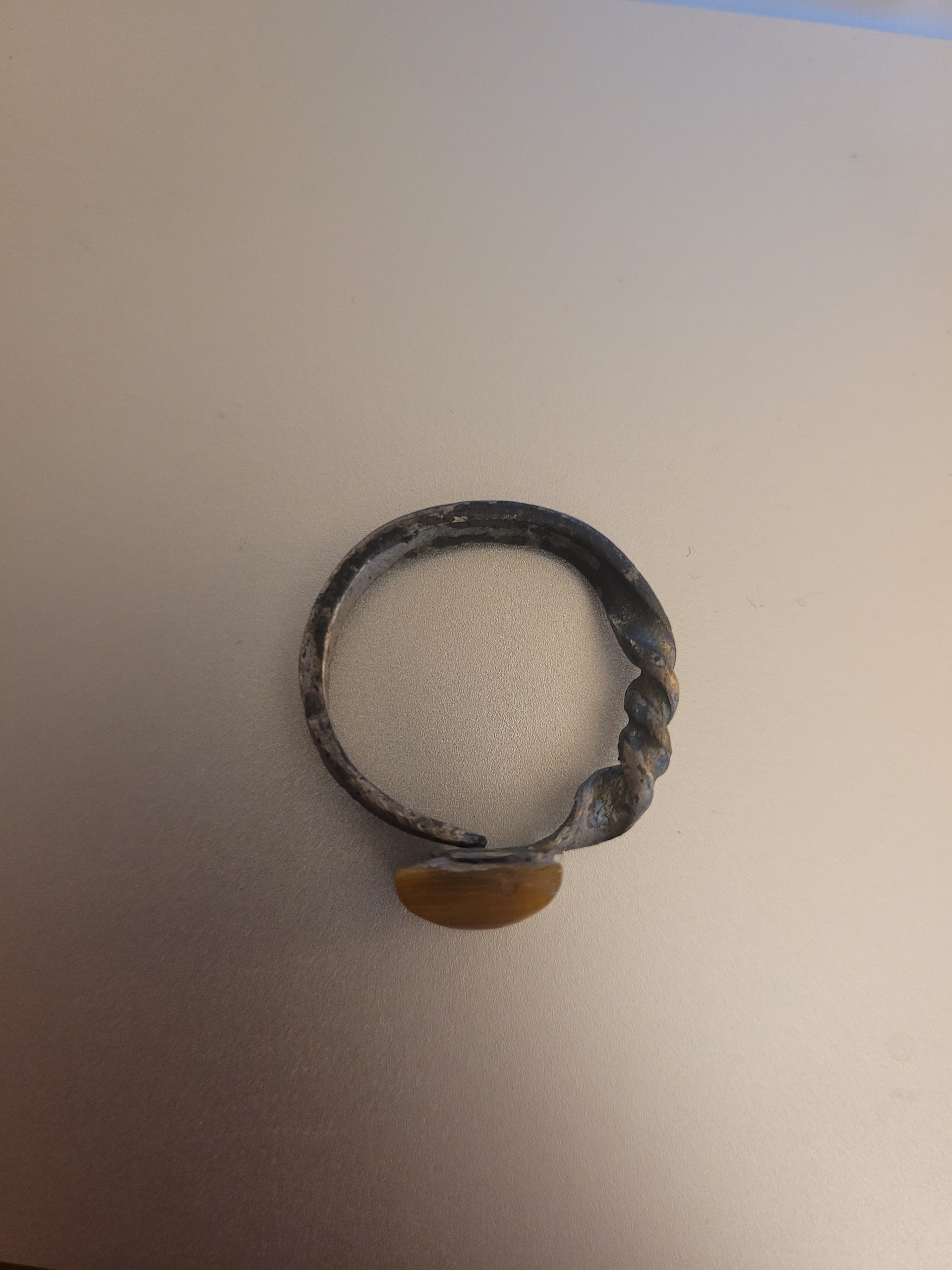 An alchemy inspired ring that was hand forged from an old nail. It is set with a square tiger's eye gemstone