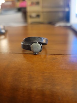 This alchemy inspired ring was handmade in the forge. It is set with a jade, making a stunning piece of rustic jewelry.