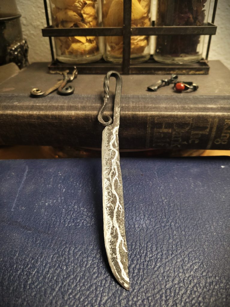 A medium shot image of a hand forged knife made by The Wayward Alchemist