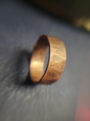 A handmade ring made of copper. It was forged by hand and hammered cold until it strengthened