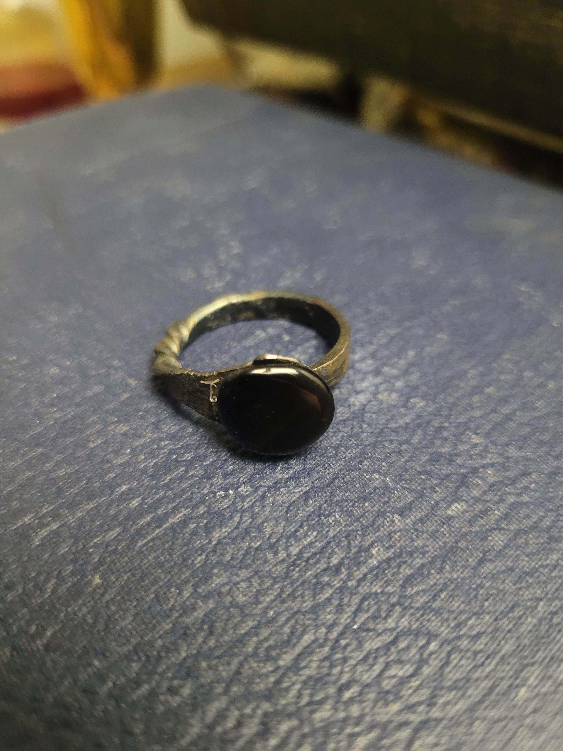 A handmade ring forged from an old nail. It is set with an obsidian stone that absorbs light