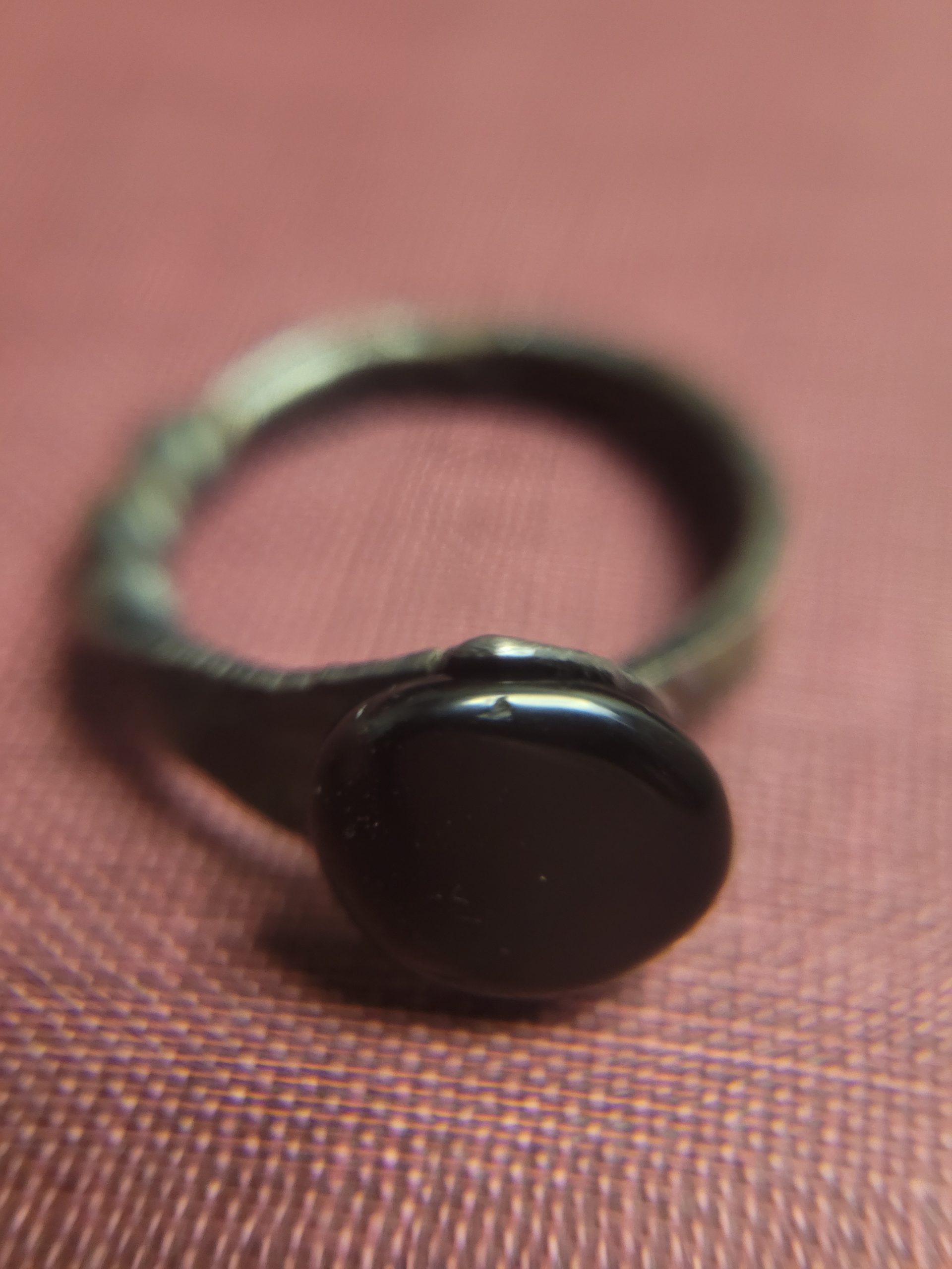 A handmade ring forged from an old nail. It is set with an obsidian stone that absorbs light