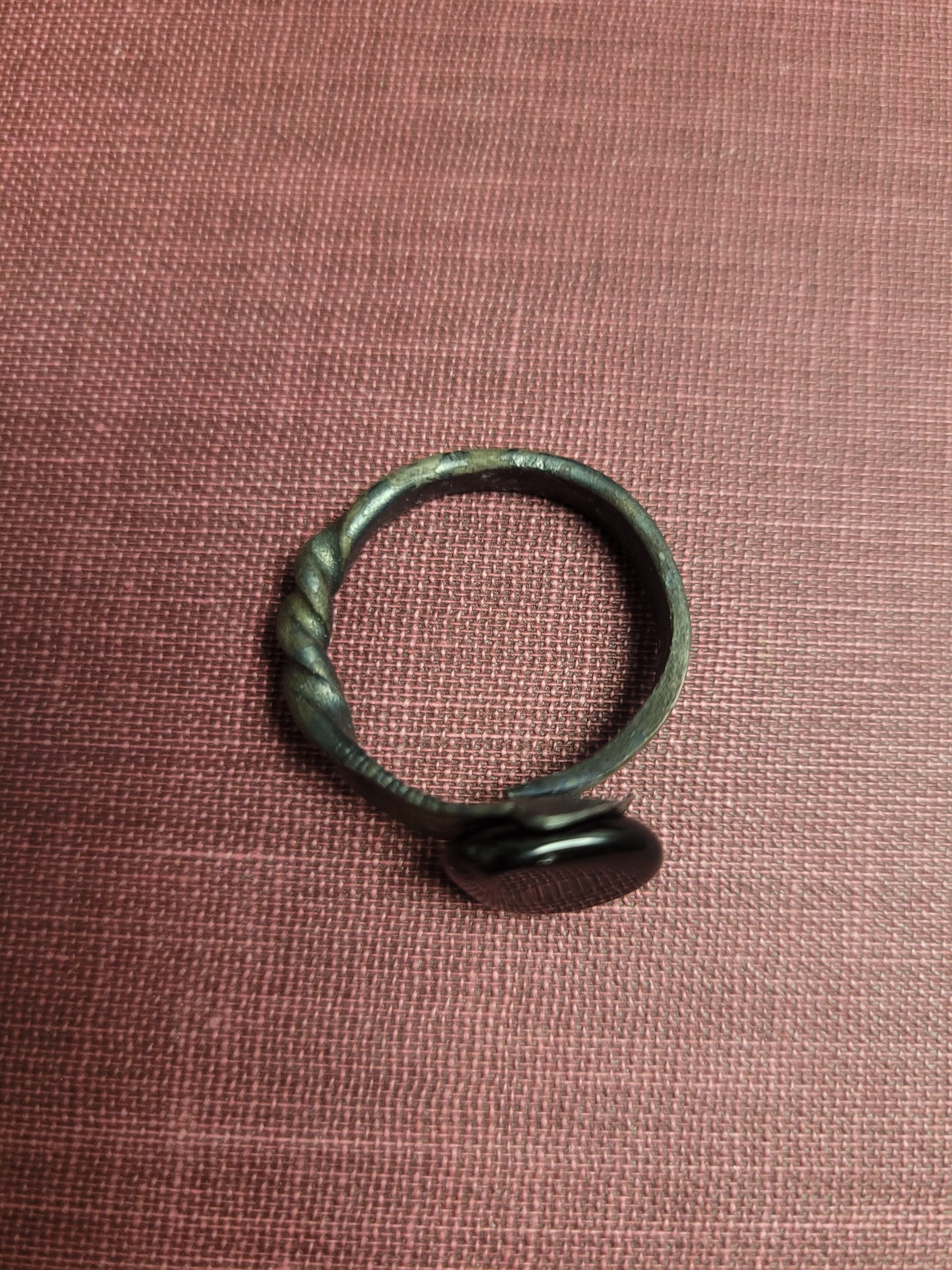 A handmade ring forged from an old nail. It is set with an obsidian stone that absorbs light