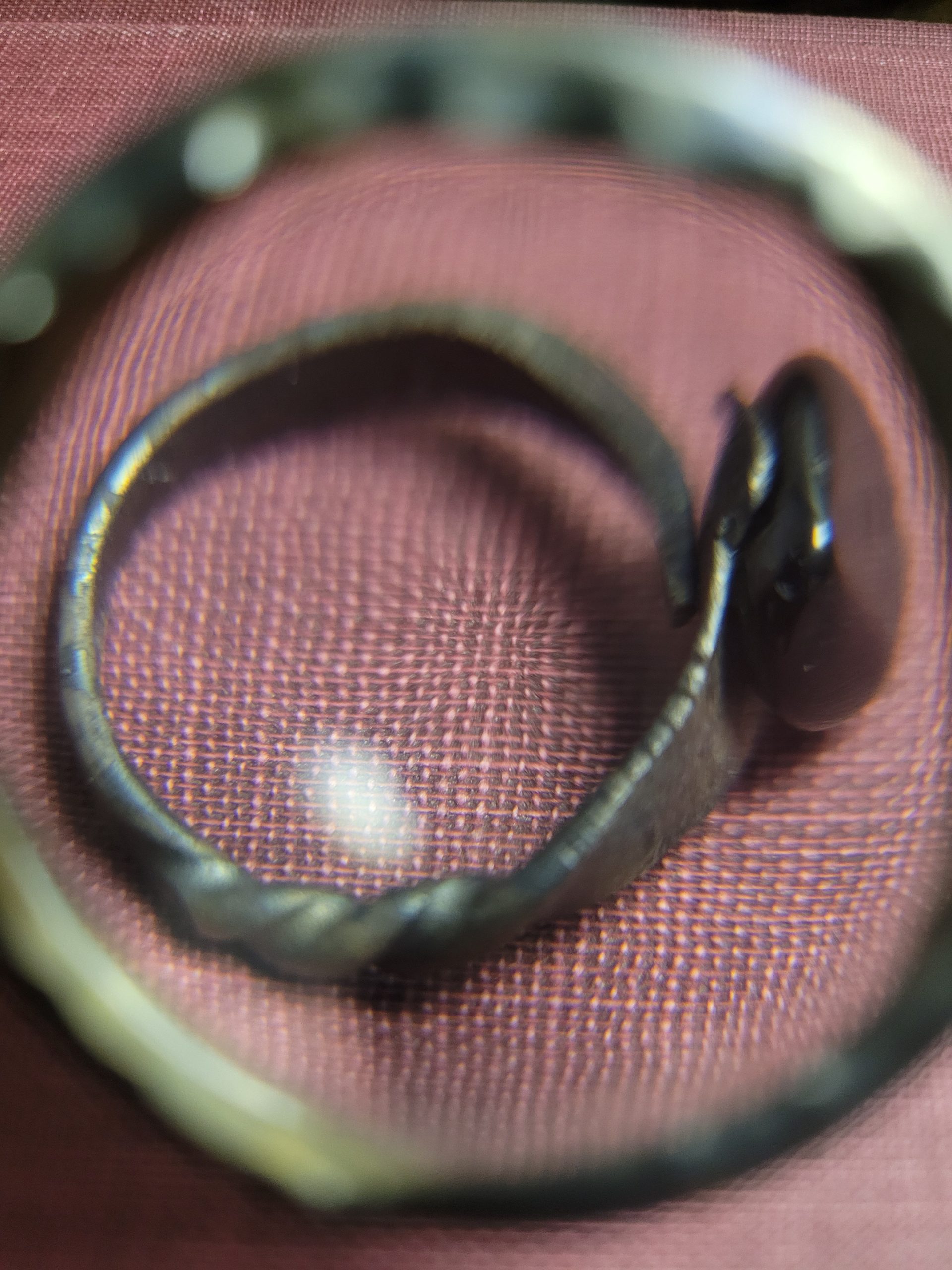 A handmade ring forged from an old nail. It is set with an obsidian stone that absorbs light