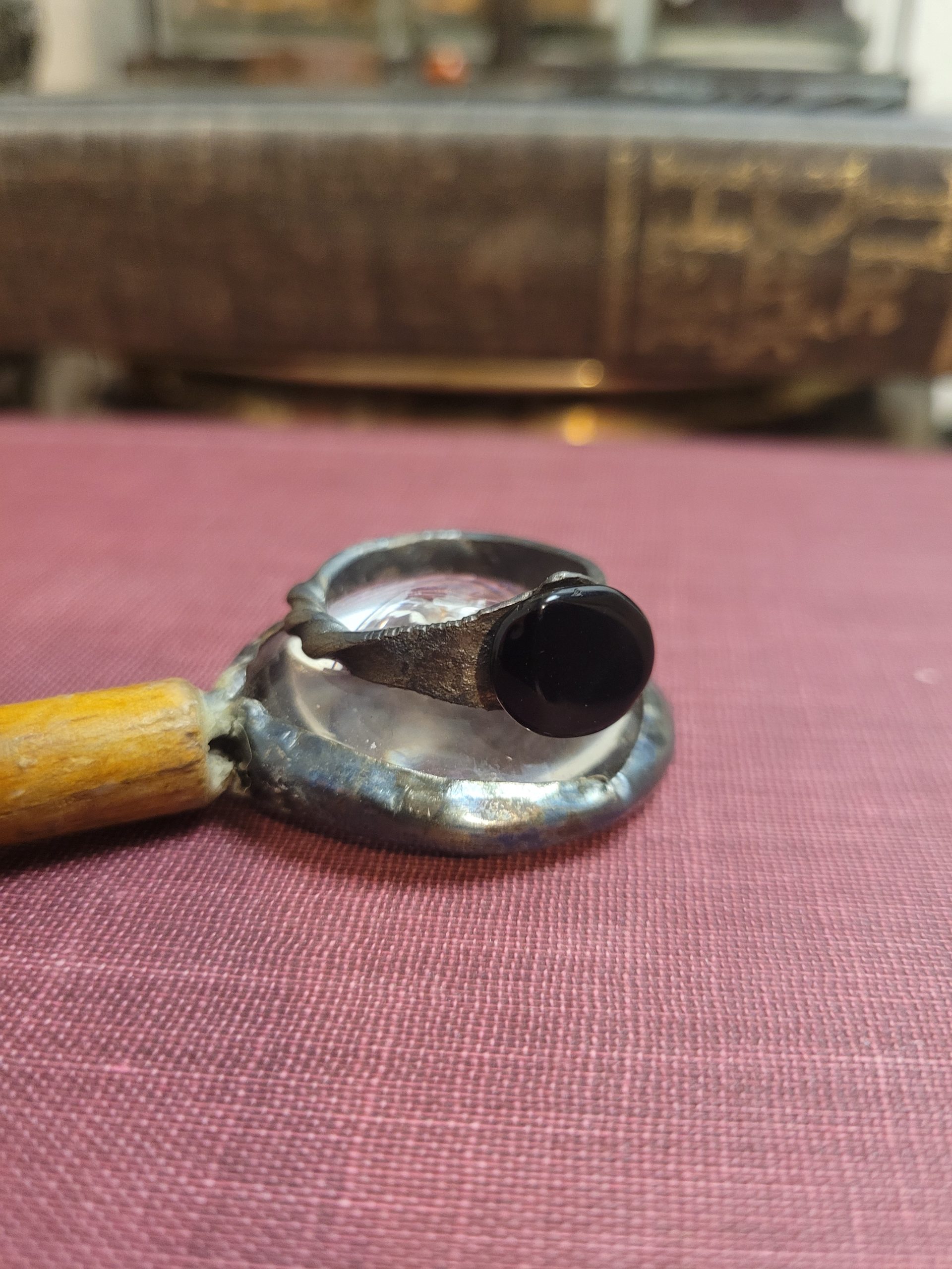 A handmade ring forged from an old nail. It is set with an obsidian stone that absorbs light