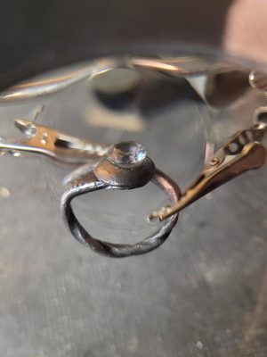 A hand forged ring made from an old nail, a bolt head, and set with clear quartz. Part of our handmade jewelry collection.